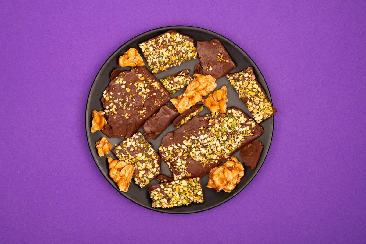 homemade organic brain-boosting bites on rustic wood board with ingredients scattered around