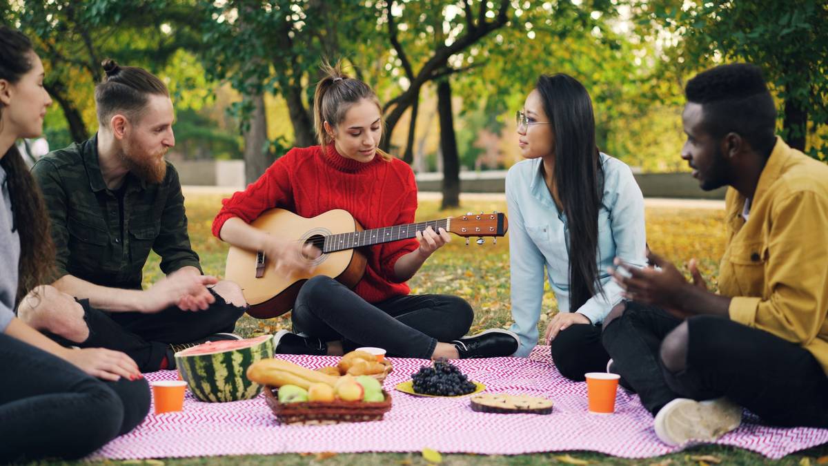 Group of diverse people sharing organic snacks at a community table with labels visible, illustrating organic snack support groups